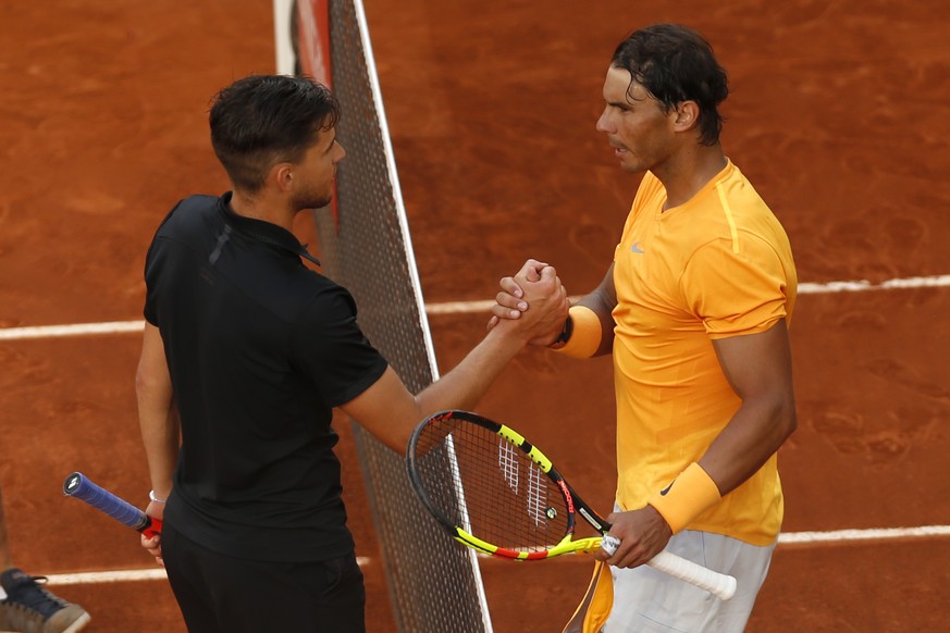 Dominic Thiem from Austria, left, shakes hands with Rafael Nadal from Spain at the end of a Madrid Open tennis tournament match in Madrid, Spain, Friday, May 11, 2018. Thiem won 7-5, 6-3. (AP Photo/Fr ...