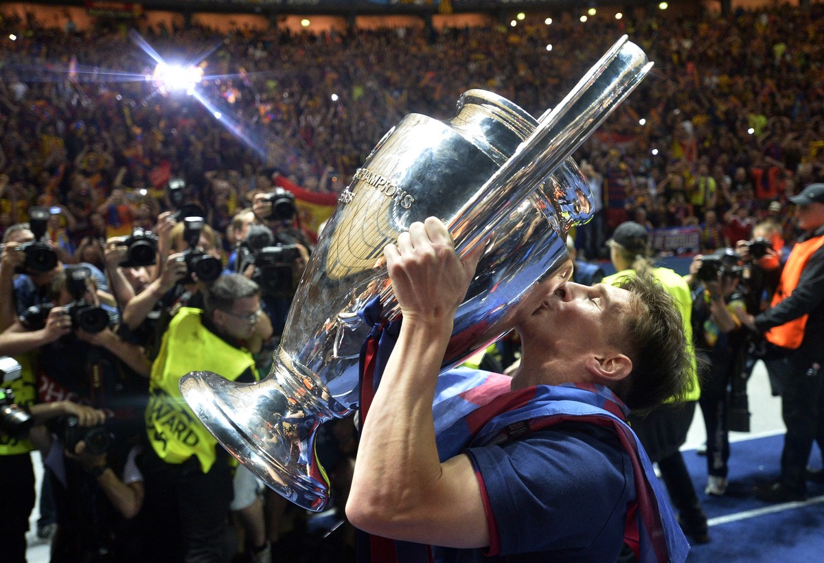 FILE - Barcelona's Lionel Messi kisses the trophy after his team won 3-1 the Champions League final soccer match between Juventus Turin and FC Barcelona at the Olympic stadium in Berlin Saturday, ...