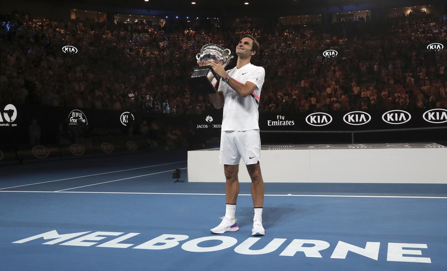 Switzerland&#039;s Roger Federer holds his trophy aloft after defeating Croatia&#039;s Marin Cilic during the men&#039;s singles final at the Australian Open tennis championships in Melbourne, Austral ...