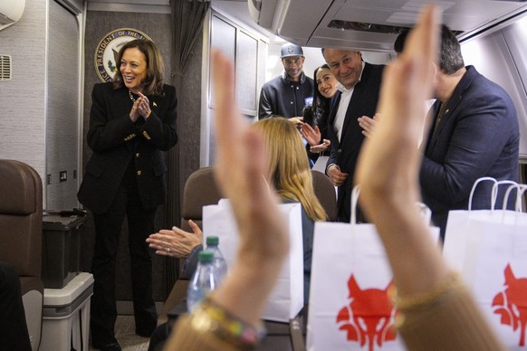 CORRECTS DATE - Democratic presidential nominee Vice President Kamala Harris, left, and her staff applaud as they congratulate each other on the end of the campaign, Tuesday, Nov. 5, 2024, aboard Air  ...