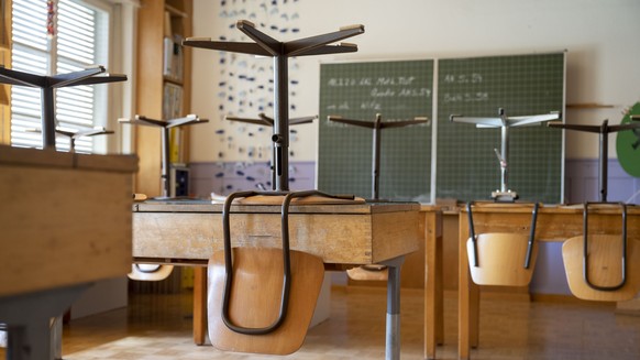 ARCHIVBILD ZUR MELDUNG, DASS DIE SCHULEN IM KANTON BERN WEGEN DER PANDEMIE BEREITS DIESEN FREITAG FUER DIE WEIHNACHTSFERIEN SCHLIESSEN WERDEN, AM DIENSTAG, 14. DEZEMBER 2021 - Stuehle stehen auf Schul ...