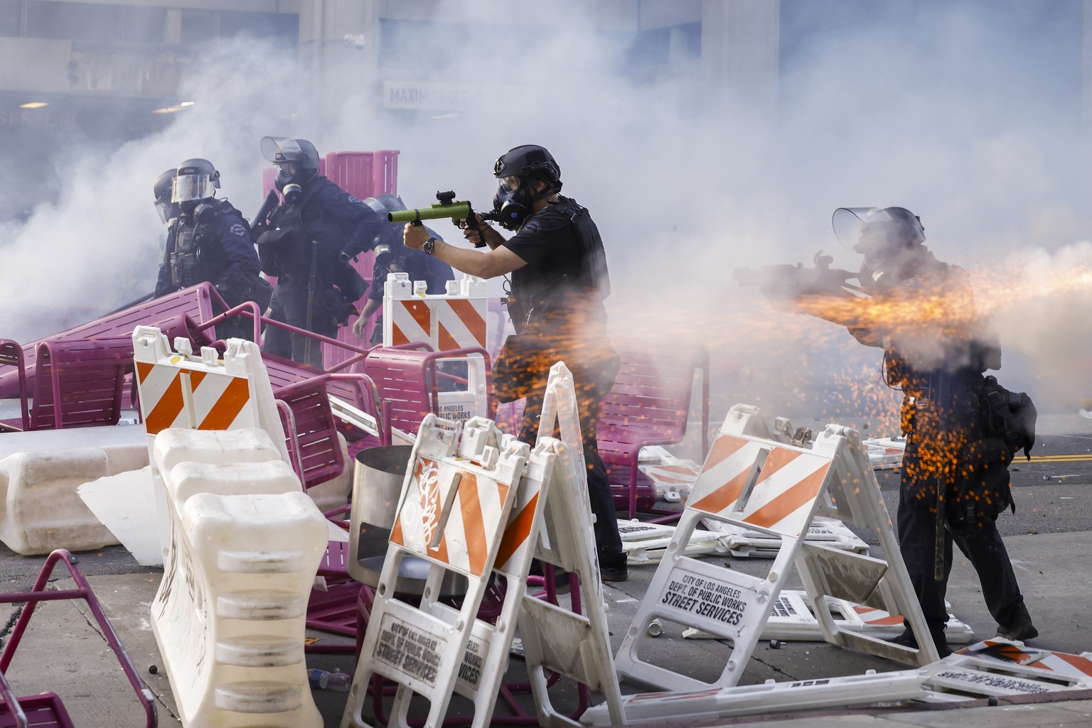 epaselect epa12165719 Police officers move to clear activists from a makeshift barricade during immigration raid protests near the Edward R. Roybal Federal Building in Los Angeles, California, USA, 08 ...