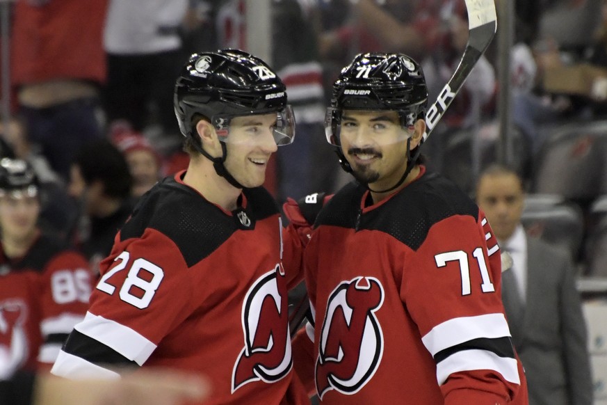 New Jersey Devils defenseman Damon Severson (28) celebrates his goal with Jonas Siegenthaler (71) during the first period of an NHL hockey game against the Ottawa Senators, Monday, Dec. 6, 2021, in Ne ...