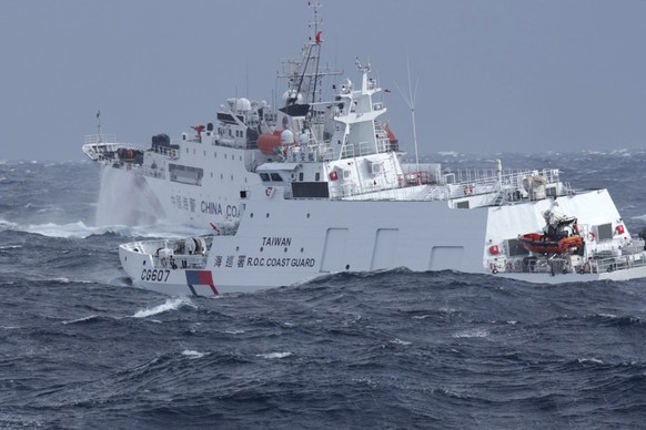In this photo released by the Taiwan Coast Guard, Taiwan Coast Guard vessel Ji An, at right, chases after Chinese Coast Guard vessel 1302 off the coast of Hualien, eastern Taiwan on Thursday, Dec. 12, ...