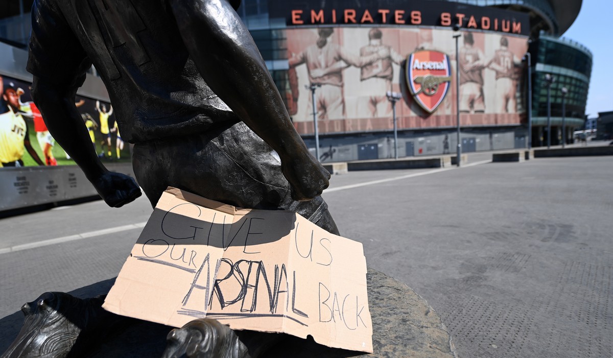 epa09146865 A sign reads, 'Give Us Our Arsenal Back' outside Arsenal's Emirates Stadium in London, Britain, 20 April 2021. Europe's top clubs from England, Italy and Spain have ann ...
