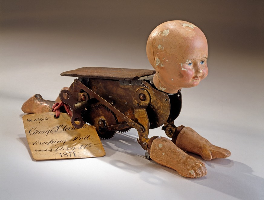 Patent model. Creeping baby doll, Clarke, 1871, patent no. 118435. 1984.0923.01.