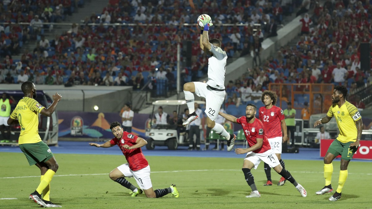 South Africa's Ronwen Williams , center, catches the ball during the African Cup of Nations round of 16 soccer match between Egypt and South Africa in Cairo International stadium in Cairo, Egypt, ...