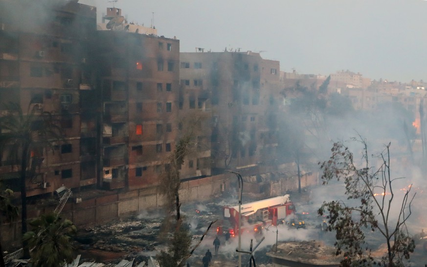 epaselect epa11223434 Firefighters try to extinguish a fire at bulding near Al-Ahram Studio in Giza, Egypt, 16 March 2024. At least four people suffered from suffocation due to smoke inhalation after  ...