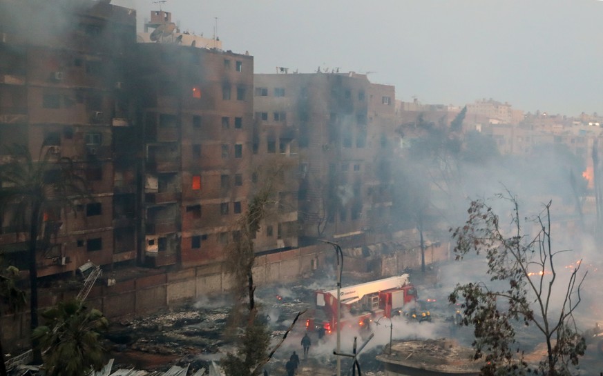 epaselect epa11223434 Firefighters try to extinguish a fire in a building near Al-Ahram Studio in Giza, Egypt, March 16, 2024. At least four people were asphyxiated from smoke inhalation after…