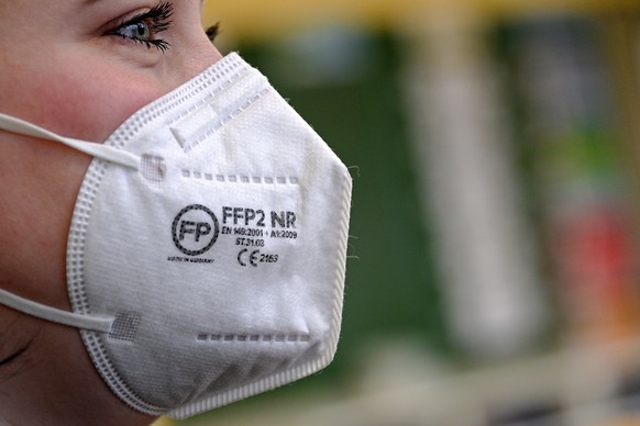 epa08947401 A woman wears a FFP2 protective mask in Cologne, Germany, 18 January 2021. Since 18 January 2021, FFP2 masks have been mandatory in Bavaria in stores, public transport and doctors&#039; of ...