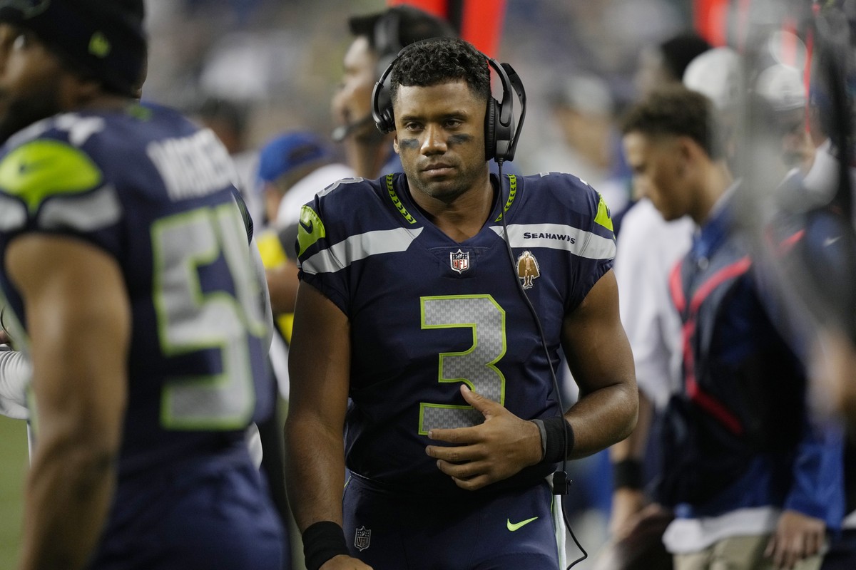 Seattle Seahawks quarterback Russell Wilson wears a headset on the sideline during the second half of the team's NFL preseason football game against the Denver Broncos, Saturday, Aug. 21, 2021, i ...