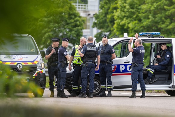 epa11339830 French policemen stand guard at the toll station of Incarville, near Rouen, in the North of France, where gunmen ambushed a prison van on 14 May 2024, killing two prison guards and helping ...
