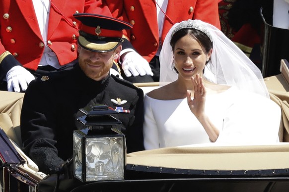 FILE - In this Saturday, May 19, 2018 file photo, Britain&#039;s Prince Harry and Meghan Markle leave Windsor Castle in a carriage after their wedding at St. George&#039;s Chapel in Windsor, near Lond ...