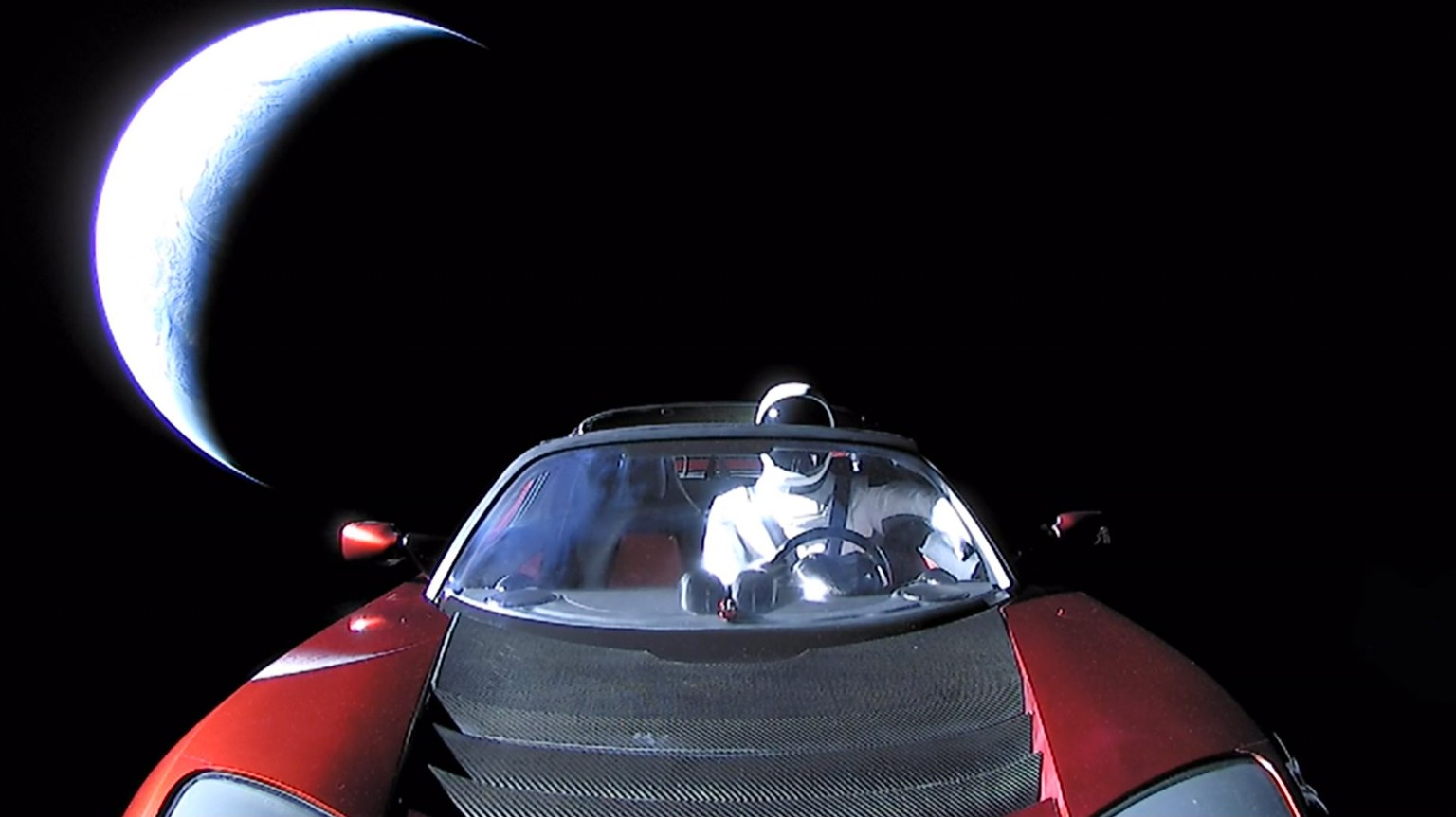 epa06506016 A handout photo made available by SpaceX on 08 Ferbuary 2018 shows a Tesla Roadster car in space after being launched with the SpaceX Falcon Heavy rocket, 06 February 2018. SpaceX, founded ...