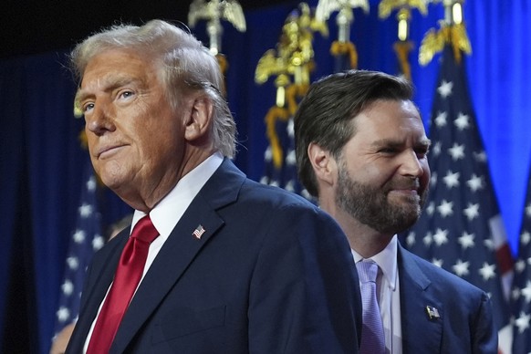 Republican presidential nominee former President Donald Trump, left, with Republican vice presidential nominee Sen. JD Vance, R-Ohio, right, at an election night watch party at the Palm Beach Conventi ...