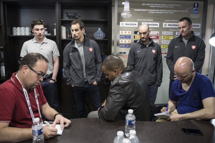 Patrick Fischer, head coach of Switzerland ice hockey team, left, speak next to his assistant coach Christian Wohlwend, center, and Tommy Albelin, right, during a media conference during the Ice Hocke ...