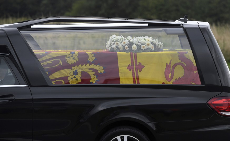 The hearse carrying the coffin of Queen Elizabeth II, draped with the Royal Standard of Scotland, passing through Dundee, Scotland, Sunday, Sept. 11, 2022, as it continues its journey to Edinburgh fro ...