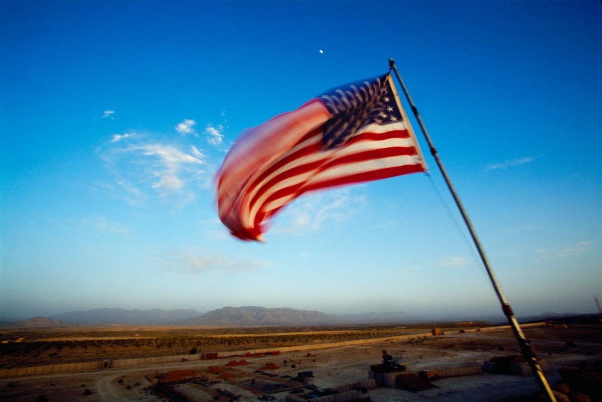 AFGHANISTAN - JULY 2004: The US flag flies on the Pashtun tribal lands, in the Pashtun tribal zone of Waziristan on July, 2004 in Afghanistan. (Photo by Reza/Getty Images)