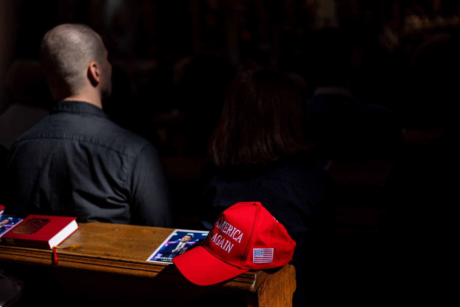 epa12382233 A portrait of US political activist Charlie Kirk and cap with sign Make America Great Again (MAGA) are placed on a church pew during a Holy Mass in Church of Our Lady before Tyn in Prague, ...