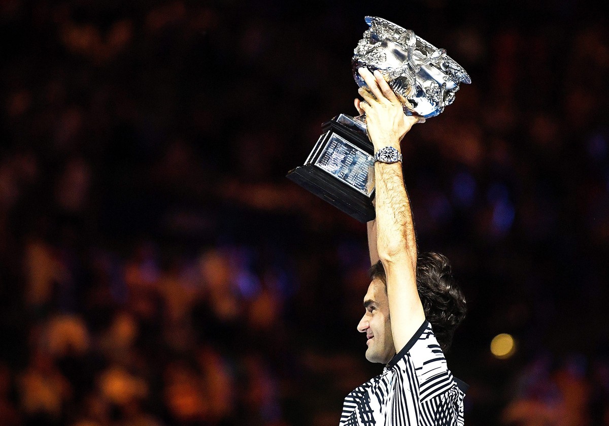 epa05759201 Roger Federer of Switzerland celebrates with the trophy after winning the Men's Singles final match against Rafael Nadal of Spain at the Australian Open Grand Slam tennis tournament i ...