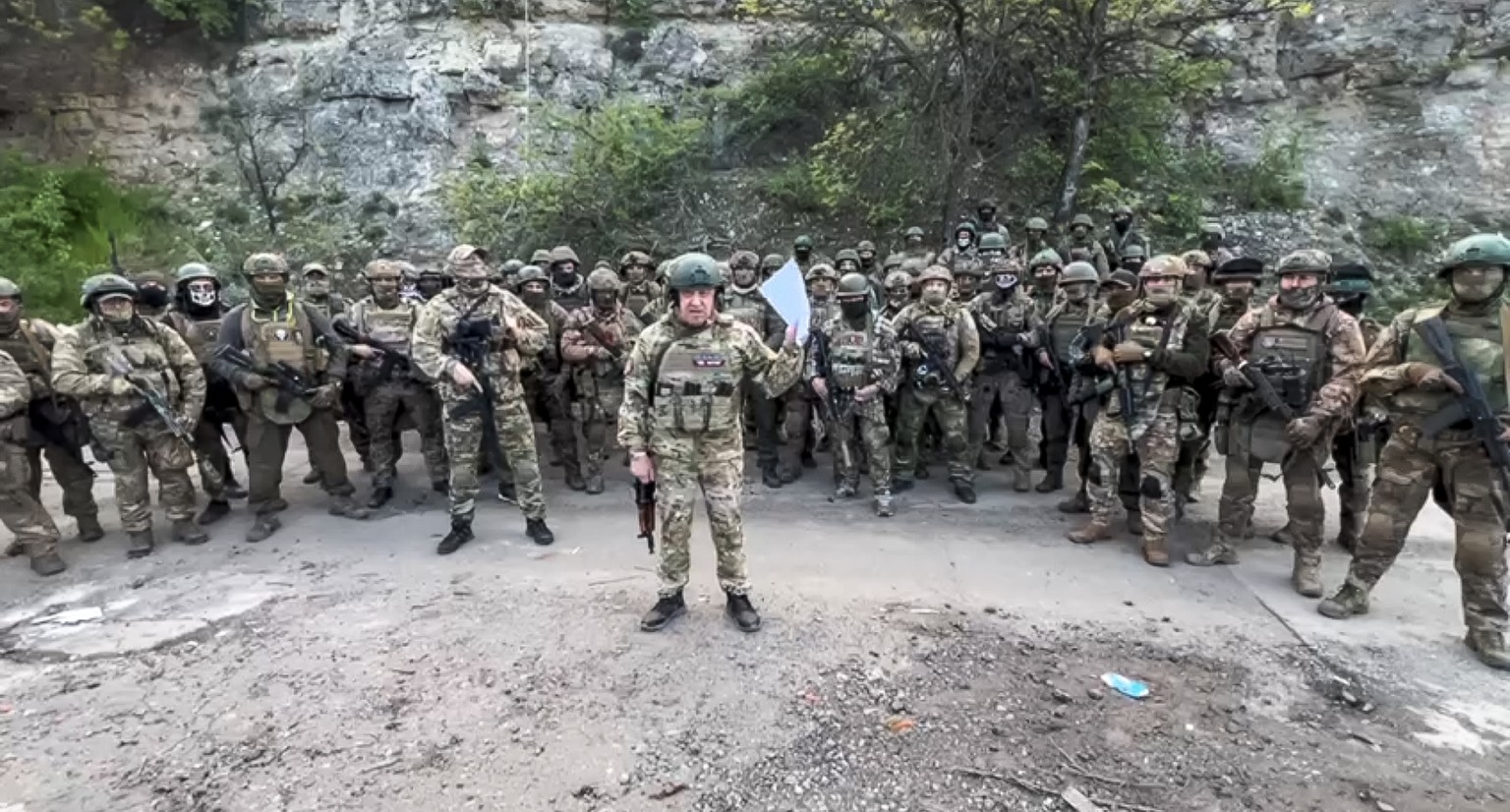 FILE - In this handout image taken from a video released by Prigozhin Press Service on May 5, 2023, head of Wagner Group Yevgeny Prigozhin reads his statement standing in front of his troops in an unk ...