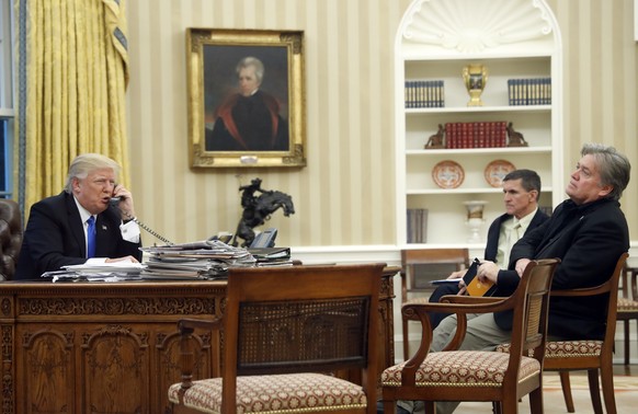 FILE - In this Jan. 28, 2017, file photo, President Donald Trump speaks on the phone with Prime Minister of Australia Malcolm Turnbull, with then-National Security Adviser Michael Flynn, center, and t ...