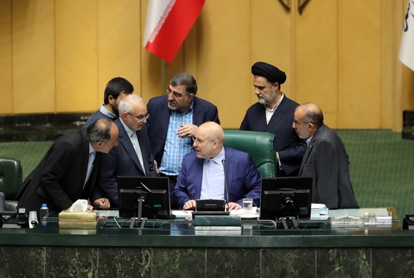epa10987083 Iranian parliament speaker Mohammad Bagher Ghalibaf (C) talks to lawmakers during a parliament session, in Tehran, Iran, 21 November 2023. The Iranian president was supposed to attend the  ...