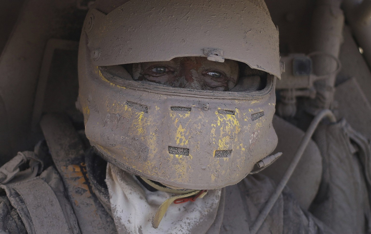 2017 AP LATIN AMERICA YEAR END PHOTOS - Suzuki car driver Tim Coronel, of the Netherlands, is covered in dirt after completing the second stage of the Dakar Rally between Resistencia and San Miguel de ...