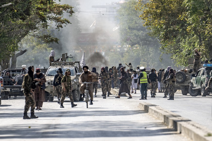 Taliban fighters stand guard at the explosion site, near a mosque, in Kabul, Afghanistan, Friday, Sept. 23, 2022. An explosion went off near a mosque in Afghanistan&#039;s capital of Kabul on Friday,  ...