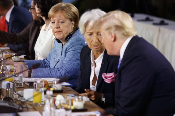 German Chancellor Angela Merkel watches as President Donald Trump talks with IMF Managing Director Christine Lagarde during the Gender Equality Advisory Council breakfast during the G-7 summit, Saturd ...