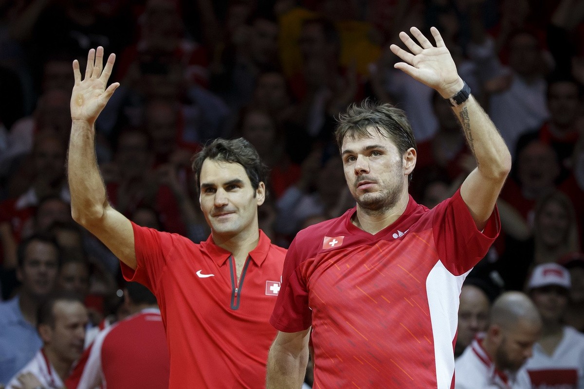 Switzerland's Roger Federer, left, and his doubles partner, Stanislas Wawrinka, right, celebrate after beating French Julien Benneteau and Richard Gasquet, during their doubles match of the Davis ...