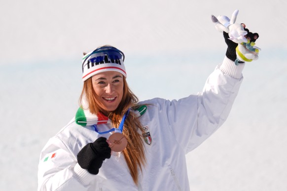 Italy's Sofia Goggia celebrates winning the bronze medal in the alpine ski women's downhill race, at the 2026 Winter Olympics, in Cortina d'Ampezzo, Italy, Sunday, Feb. 8, 2026. (AP Pho ...