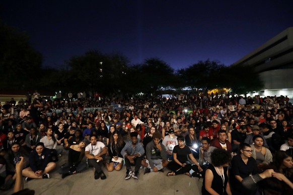 Students from University of Nevada Las Vegas hold a vigil Monday, Oct. 2, 2017, in Las Vegas. A gunman on the 32nd floor of the Mandalay Bay casino hotel rained automatic weapons fire down on the crow ...