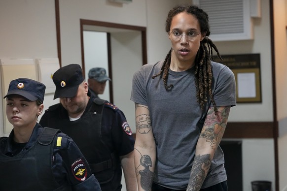 FILE - WNBA star and two-time Olympic gold medalist Brittney Griner is escorted from a courtroom after a hearing in Khimki just outside Moscow, on Aug. 4, 2022. Russia has freed WNBA star Brittney Gri ...