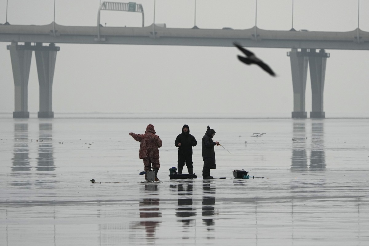 Men fish on melting ice not far from shore on the Gulf of Finland in St. Petersburg, Russia, Wednesday, Jan. 29, 2025, during unusually warm weather with temperatures at 5 degrees Celsius (41 degrees  ...