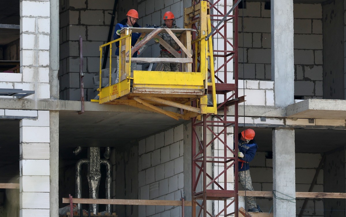 epa12200704 Builders work at a developing building project of a new district of apartment houses of one of the largest Russian developers Samolet in Moscow, Russia, 27 June 2025. Banks in Russia began ...