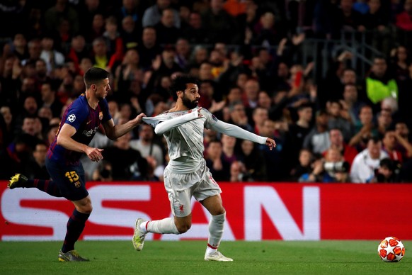 epa07541210 FC Barcelona&#039;s defender Clement Lenglet (L) duels for the ball against Liverpool&#039;s winger Mohammed Salah (R) during the UEFA Champions League first leg semifinal match between FC ...