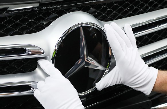 epa07486367 (FILE) - A worker attaches a Mercedes star at the C Class and GLC Class production line during a photo opportunity for the media at the Mercedes Cars factory in Bremen, northern Germany, 2 ...