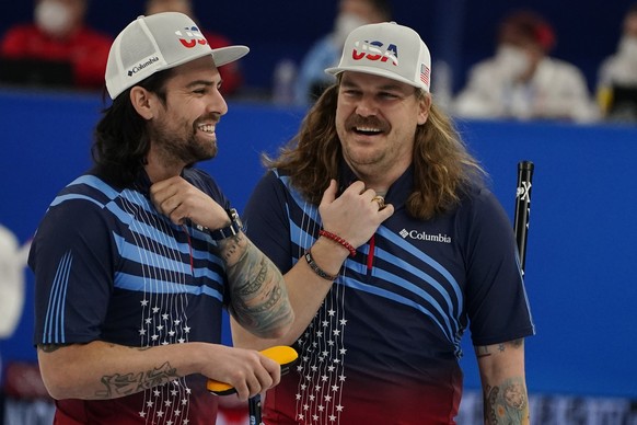 United States&#039; Christopher Plys, left, and Matt Hamilton, right, talk between plays during a men&#039;s curling match against Sweden at the Beijing Winter Olympics Thursday, Feb. 10, 2022, in Bei ...