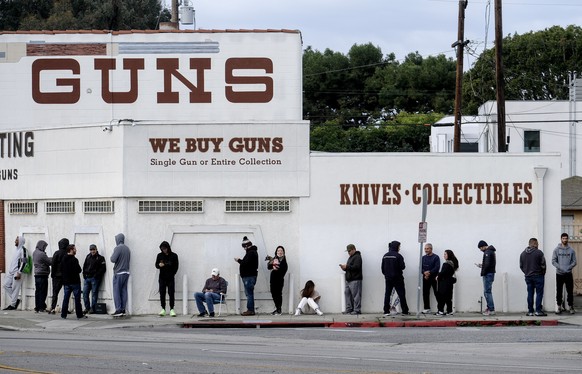People wait in a line to enter a gun store in Culver City, Calif., March 15, 2020. (AP Photo/Ringo H.W. Chiu)