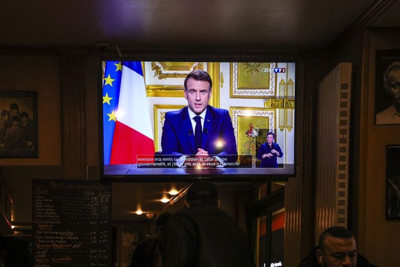 epa11759130 A screen shows the French President Emmanuel Macron delivering a televised speech to the French nation, in Paris, France, 05 December 2024. French President Emmanuel Macron addressed the n ...