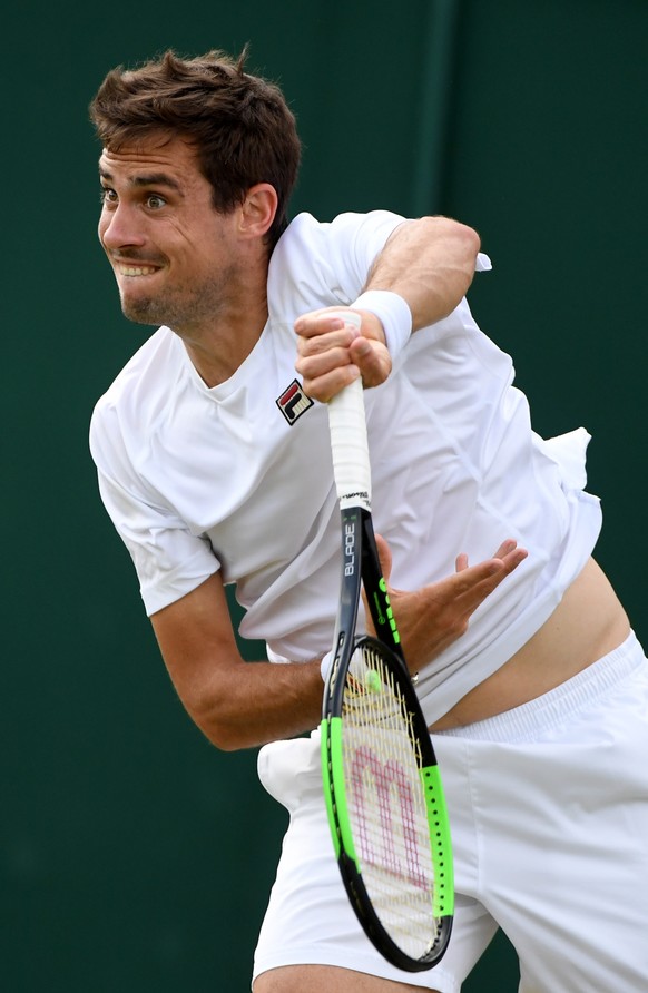 epa07704027 Guido Pella of Argentina in action against Milos Raonic of Canada during their fourth round match for the Wimbledon Championships at the All England Lawn Tennis Club, in London, Britain, 0 ...