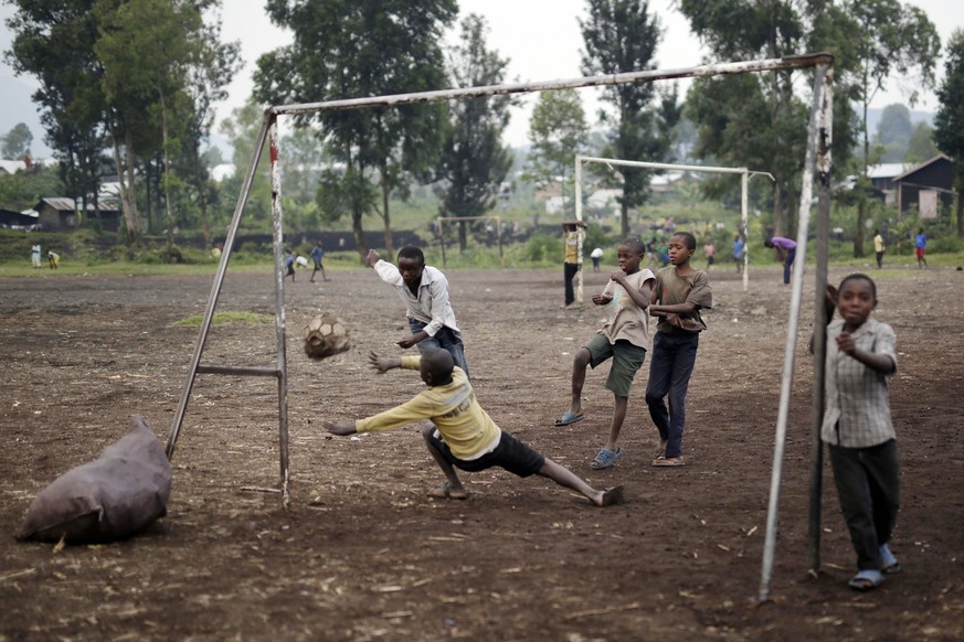 Congolese children play football on a dirt field in Goma, Democratic Republic of Congo, Saturday June 18, 2016. One goal was scored with the old deflated ball the children use to play with. (AP Photo/ ...