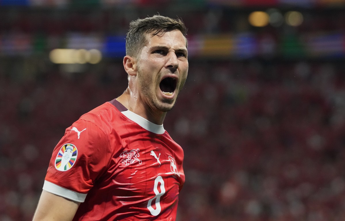 Switzerland's Remo Freuler celebrates after teammate Dan Ndoye scored his side's opening goal a Group A match between Switzerland and Germany at the Euro 2024 soccer tournament in Frankfurt, ...