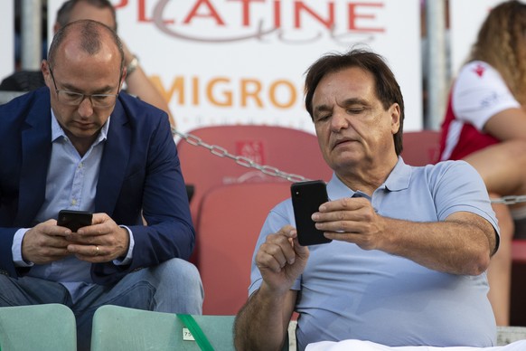 Alexandre Zen-Ruffinen, left, lawyer of FC Sion, and Christian Constantin, President of FC Sion, look on their smart phone, right, prior the Super League soccer match between FC Sion and BSC Young Boy ...