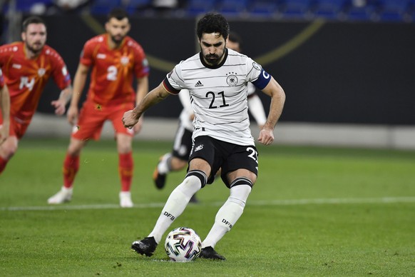 Germany's Ilkay Gundogan scores on penalty his side's first goal during the World Cup 2022 group J qualifying soccer match between Germany and North Macedonia in Duisburg, Germany, Wednesday ...