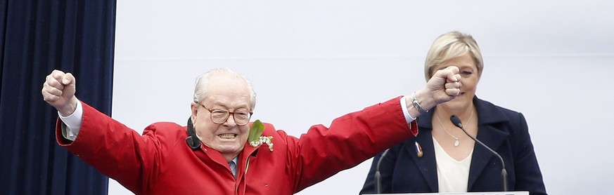 JAHRESRUECKBLICK 2015 - MAI - Former President of the Front National (FN) Jean-Marie Le Pen (L) gestures toward the audience as his daughter, the actual president, Marine Le Pen (R) looks on during th ...