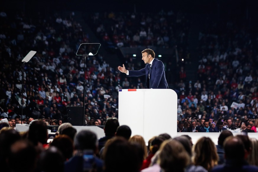 epaselect epa09866169 French President and liberal party La Republique en Marche (LREM) candidate for re-election Emmanuel Macron (C) deliver a speech during his first campaign meeting at the Paris La ...