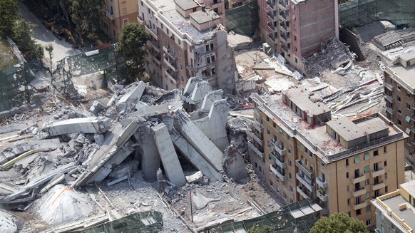 An aerial view of the remains of the Morandi bridge in Genoa, Italy, Saturday, June 29, 2019. A spectacular planned explosion Friday knocked down the remaining spans and supporting columns of the Ital ...