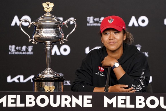 Japan&#039;s Naomi Osaka sits next to her trophy, the Daphne Akhurst Memorial Cup at a press conference after defeating United States Jennifer Brady in the women&#039;s singles final at the Australian ...